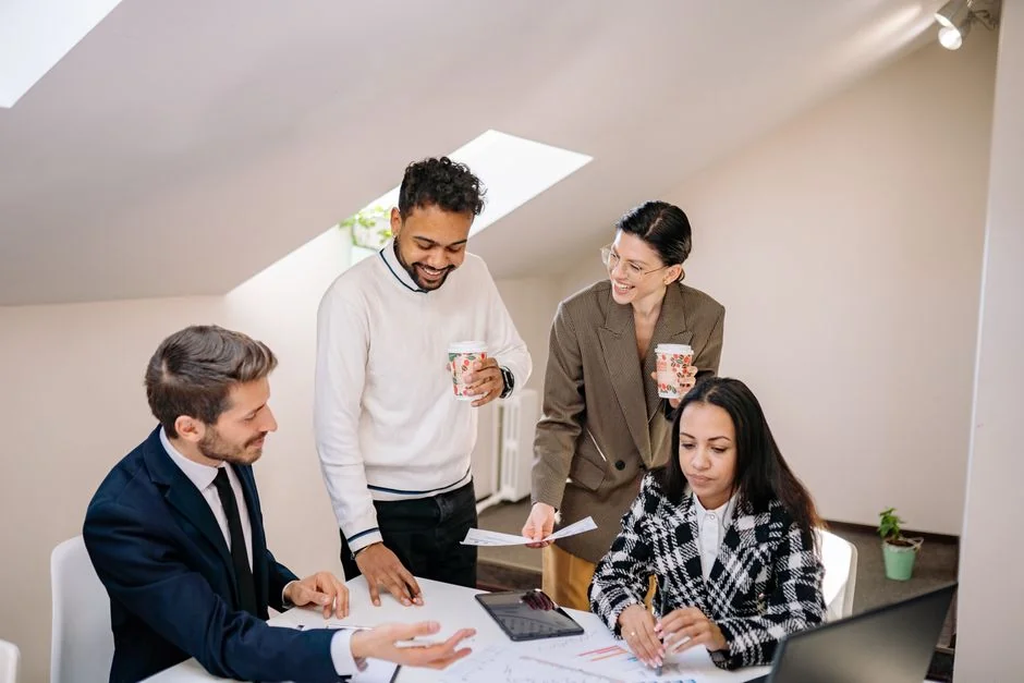 Hands discussing marketing strategy with charts in an office setting.